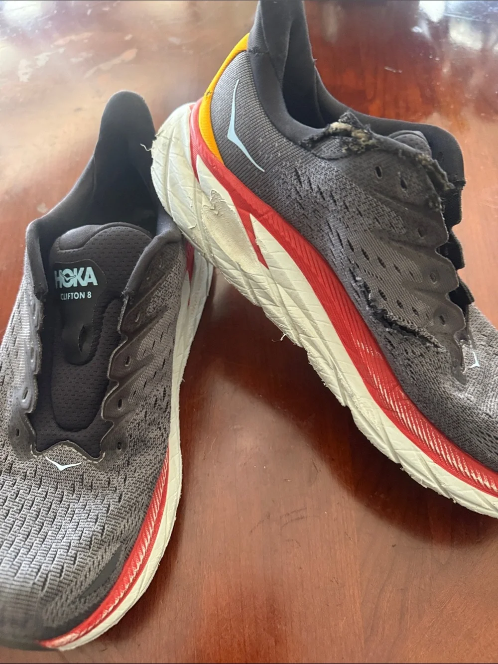 Hoka Men's Gray and Black Running Sneakers with Red and Yellow Accents